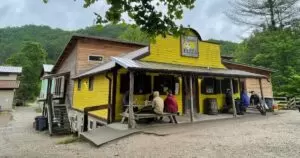 Girl helping a younger child with a belt at Red River Gorge lodging, Kentucky.