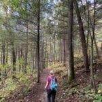 Hiker on Indian Stair Case trail, Red River Gorge, KY in fall, exploring fun mystery hike experiences.