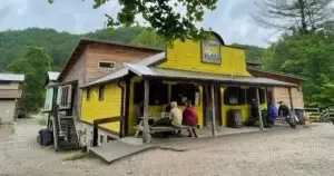 Girl helping a younger child with a belt at Red River Gorge lodging, Kentucky.