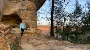 Girl helping a younger child with a belt at Red River Gorge lodging, Kentucky.