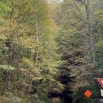 15 Reasons Why You Should Hike the Indian Stair Case this Fall in the Red River Gorge, KY 6 Road leading into a rock tunnel in Red River Gorge, KY, surrounded by fall foliage. Hike the Indian Stair Case this fall!